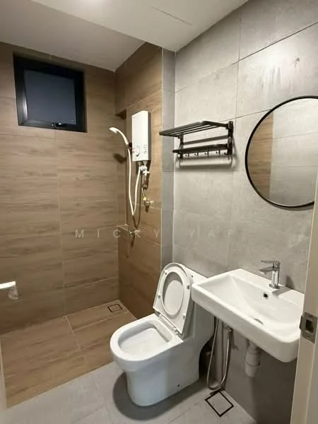 Bathroom features: grey tile walls, wood-look tile accent wall, round mirror, chrome basin mixer faucet, white sink, one-piece toilet, shower with handheld showerhead, wall-mounted water heater, towel rack, window for natural light; style: modern.