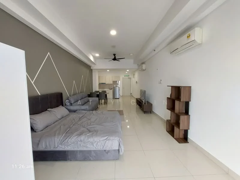 Living features: grey fabric sectional sofa, queen-size bed with grey bedding, white painted walls, recessed downlights, 5-blade ceiling fan, glossy tile flooring, wall-mounted air conditioning unit, wooden bookshelf, kitchen area visible in background; style: modern.