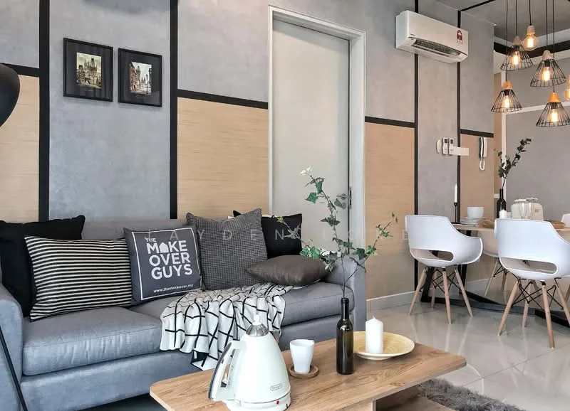 Living features: grey fabric sofa, black and white striped throw pillows, decorative throw blanket, wooden coffee table, white ceramic kettle, black decorative bottle, candles on table, recessed downlights, pendant lighting with multiple bulbs, wall-mounted air conditioning unit, light grey painted walls, wood panel accent wall, white dining chairs, dining table in background; style: modern.