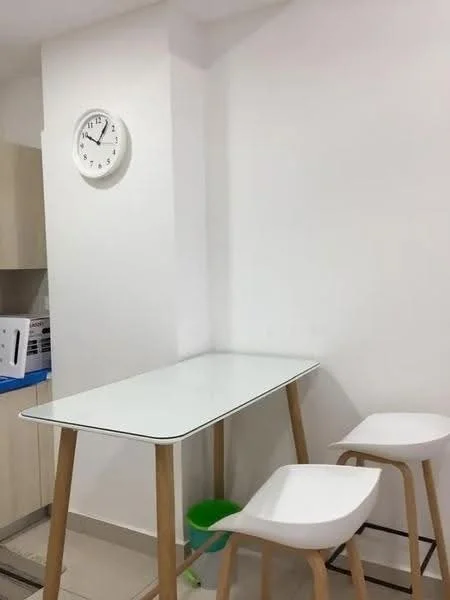 Room features: white painted walls, light-colored cabinetry, white table with wooden legs, two white stools, clock on wall, tile flooring; style: modern.