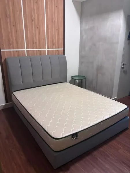 Bedroom features: king-size bed, upholstered headboard in grey, wooden accent wall, grey painted wall, laminate flooring, nightstand with glass top, door to hallway, minimalist decor; style: modern.