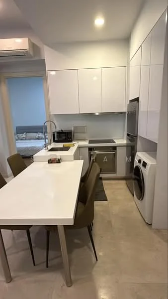Kitchen features: white cabinetry with flat-panel doors, stainless-steel sink, chrome pull-down faucet, white quartz countertop, built-in oven, stainless-steel refrigerator, front-load washing machine, 4-burner gas hob, pendant lighting, tile flooring, open layout with dining area, bar seating with white table, upholstered dining chairs in beige; style: modern.
