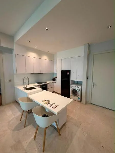 Kitchen features: white cabinetry, marble countertop, stainless-steel sink, chrome pull-down faucet, built-in oven, freestanding range oven, microwave, stainless-steel fridge, front-load washing machine, pendant lighting, recessed downlights, bar seating with two stools, cream tile flooring, white walls; style: modern.