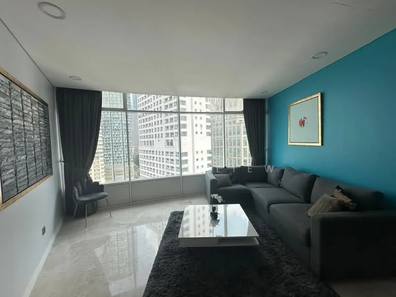 Living features: grey fabric sectional sofa, marble coffee table, floor-to-ceiling windows, city skyline view, blue accent wall, white painted walls, sheer curtains, recessed downlights, decorative artwork on wall, area rug; style: modern; view: city.