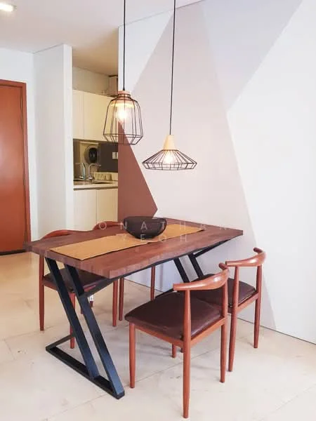 Dining features: wood dining table with black metal legs, 4 dining chairs with wooden frames and upholstered seats, pendant light fixtures with wire cages, light fixture with a white shade, geometric accent wall with two-tone paint, cream-colored walls, tile flooring, open kitchen view in background; style: modern.