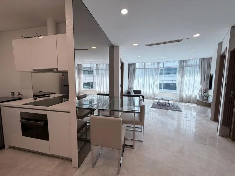 Kitchen features: white cabinetry, black countertop, built-in oven, stainless-steel cooktop, exhaust hood, refrigerator, open shelving; style: modern. Dining features: glass dining table, 4 beige upholstered chairs, pendant lighting, marble flooring; style: modern. Living features: floor-to-ceiling windows, sheer curtains, sofa, area rug, TV console, wall-mounted TV; style: modern; view: city.