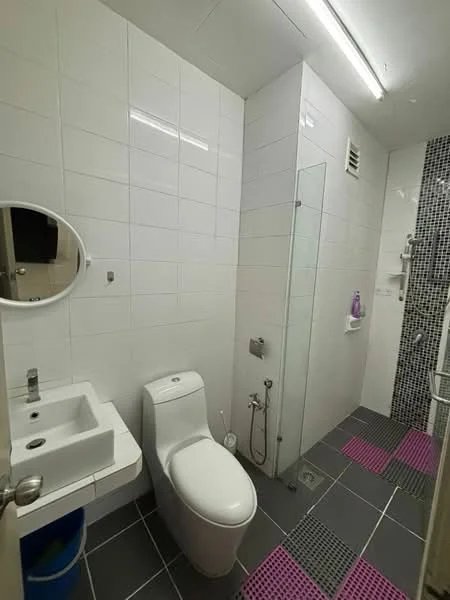 Bathroom features: white tiled walls, grey ceramic tile flooring, single-sink vanity with wall-mounted faucet, round mirror, one-piece toilet, handheld shower, glass shower enclosure, shower wall with mosaic tile, toilet bidet spray, shelf for toiletries; style: modern.