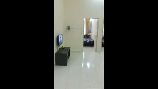 Room features: white painted walls, glossy tile flooring, wall-mounted TV, TV console, doorway leading to another room, curtains on windows, light-colored ceiling, minimalist decor; style: modern.