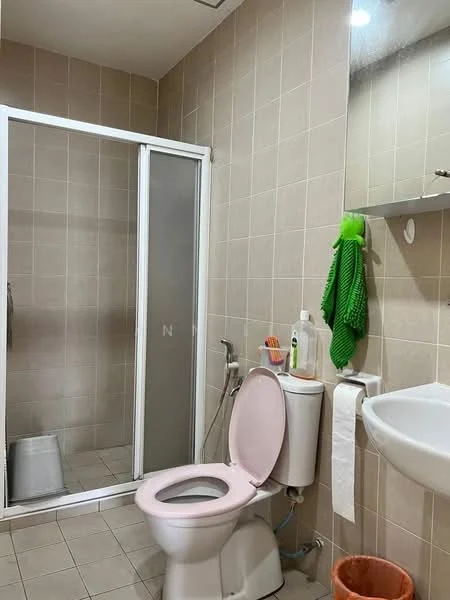 Bathroom features: light beige tiled walls, white ceramic floor tiles, glass shower enclosure, pink toilet, white sink, mirror above sink, towel rack, green towel, toilet paper holder, shower head, handheld shower, soap dispenser; style: modern.