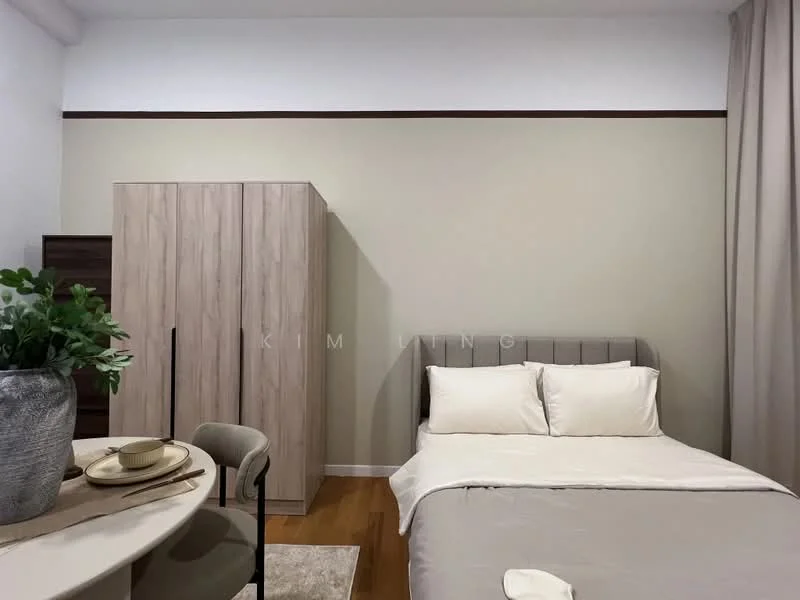 Bedroom features: queen-size bed with white bedding, upholstered headboard in grey, wooden flooring, light beige painted walls, dark wood wardrobe, round dining table with beige upholstery, decorative plant in a ceramic pot, curtains in light fabric, area rug with neutral tones; style: modern.