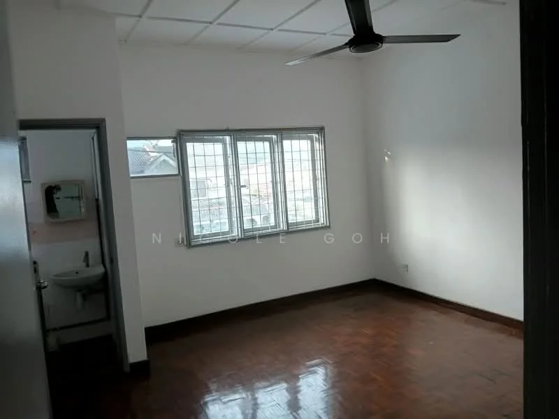 Room features: white painted walls, wooden flooring, ceiling fan, window with metal grille, natural light from window, corner sink visible in adjacent room, square ceiling tiles.