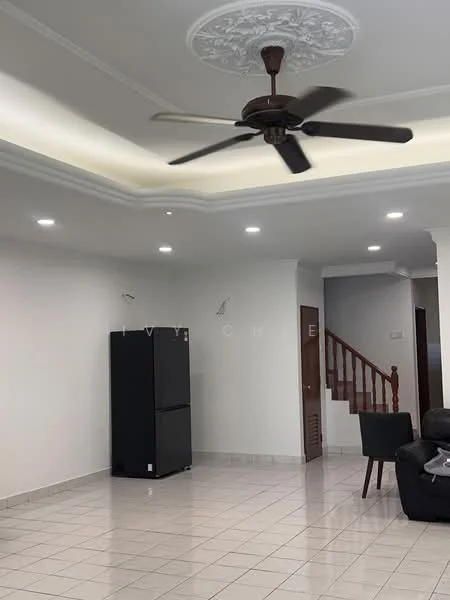 Living features: white painted walls, tile flooring, tray ceiling with crown moulding, 5-blade ceiling fan, recessed LED downlights, black refrigerator, staircase in background, dark leather sofa, wooden staircase railing; style: modern.