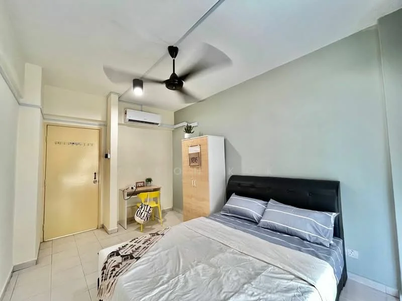 Bedroom features: king-size bed with black upholstered headboard, white bedding, ceiling fan with light, wall-mounted air conditioning unit, light green painted walls, white tiled flooring, built-in wardrobe with wooden finish, small study desk with yellow chair, decorative plant on top of wardrobe, door leading to hallway; style: modern.
