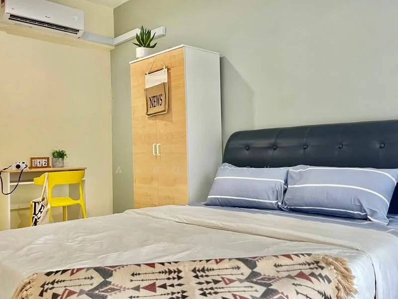 Bedroom features: king-size bed with upholstered headboard, white bedding, two blue pillows, wooden bedside table, study desk with yellow chair, built-in wardrobe with white doors, wall-mounted air conditioning unit, decorative blanket with geometric pattern, green painted walls, wooden flooring; style: modern.