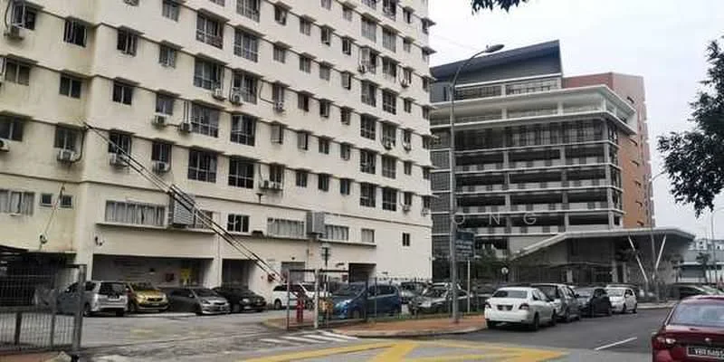 Exterior type: mid-rise condominium; features: white painted facade, glass curtain wall, multiple air conditioning units visible, parking lot with several cars, covered entrance with awning, surrounded by urban environment; style: modern.