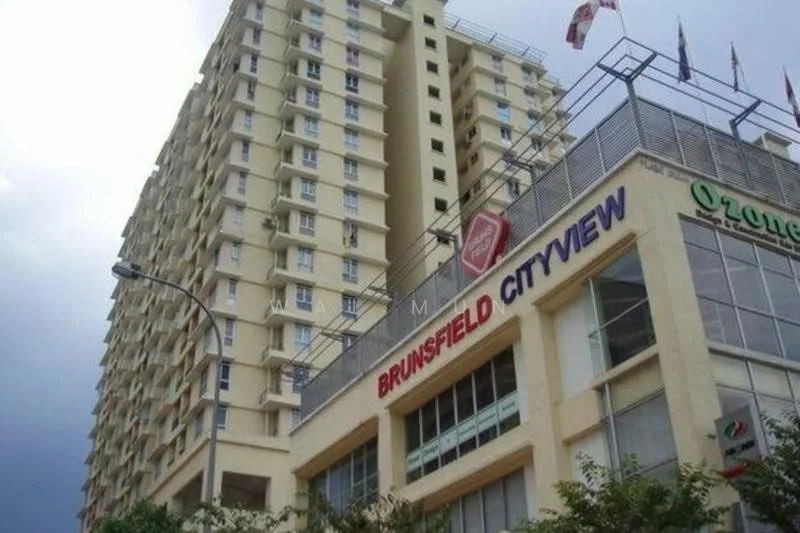 Exterior type: high-rise condominium; features: cream painted facade, glass windows, multiple balconies, signage with 'BRUNSFIELD CITYVIEW', multiple floors, surrounded by greenery, flag poles with flags, commercial space at ground level; style: modern.