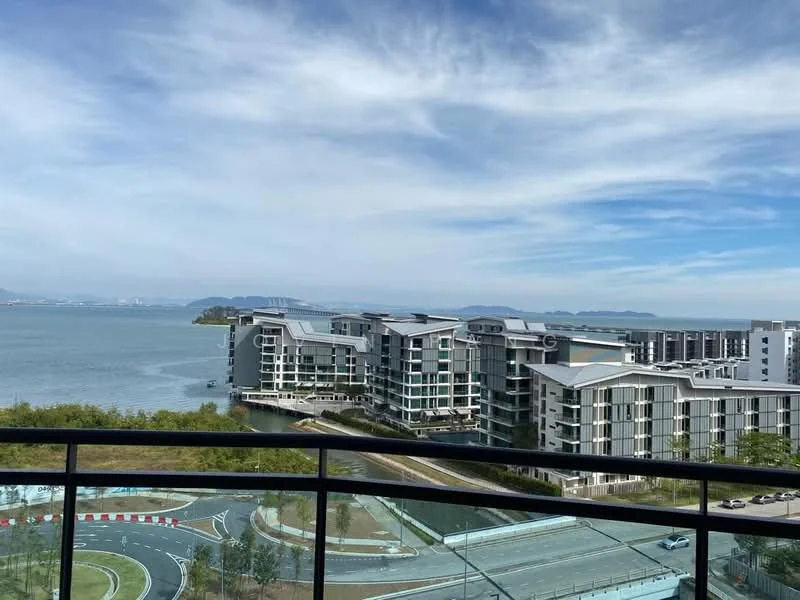 Exterior type: high-rise condominium; features: glass curtain wall, balconies with glass railings, surrounded by water, landscaped gardens, view of the sea, modern architectural design, multiple building blocks, road access in foreground; style: modern.