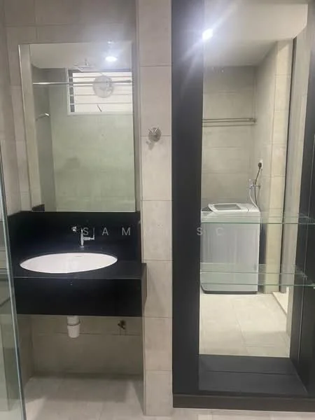 Bathroom features: single-sink vanity with black countertop, round white sink, mirror with frame, glass shower enclosure, tile flooring, light-colored wall tiles, washing machine, shelf unit, wall-mounted towel rack; style: modern. Laundry features: washing machine, shelf unit, light-colored wall tiles, tile flooring; style: modern.