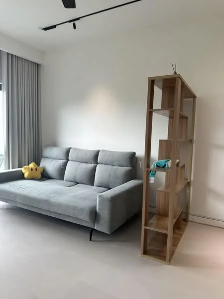 Living features: grey fabric sectional sofa, light wood open shelving unit, white painted walls, light-colored flooring, floor-to-ceiling windows with sheer curtains, ceiling fan, decorative plush toy, minimalist decor; style: modern.