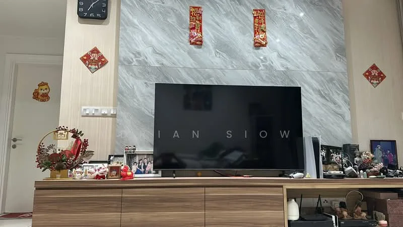 Living features: grey marble accent wall, wooden TV console, large flat-screen TV, decorative items on console, wall clock, framed photographs, red decorative wall hangings, houseplants, open shelving, neutral wall color, laminate flooring; style: modern.