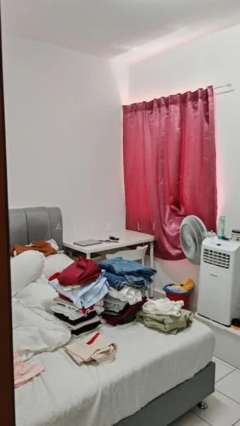 Bedroom features: queen-size bed with grey upholstered headboard, white bedding, stacked laundry on bed, white walls, pink curtains, floor-mounted air conditioning unit, small desk with chair, tile flooring, table lamp, wall-mounted mirror.