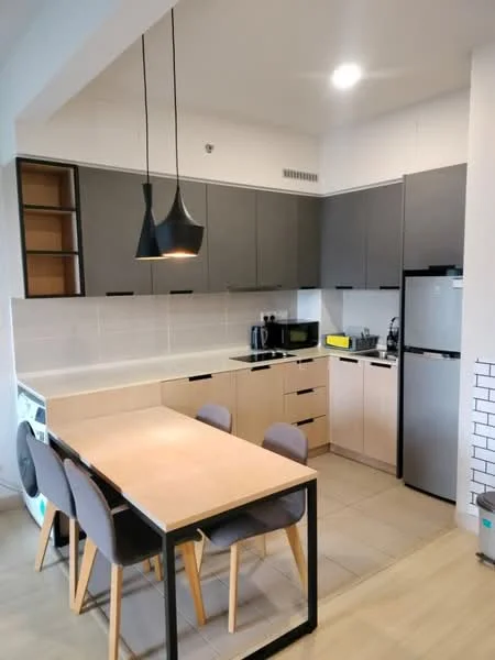 Kitchen features: grey upper cabinets, beige lower cabinets, white countertop, stainless-steel fridge, built-in microwave, black pendant light, 4-seater dining table, grey upholstered dining chairs, ceramic tile flooring, white tiled backsplash, kitchen sink, chrome faucet, electric kettle; style: modern.