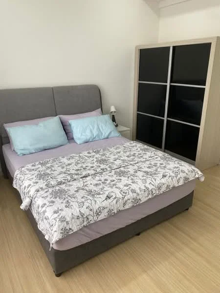 Bedroom features: queen-size bed with grey upholstered headboard, light purple bedding, floral patterned throw blanket, two light blue pillows, wooden flooring, black sliding door wardrobe, table lamp on bedside table; style: modern.