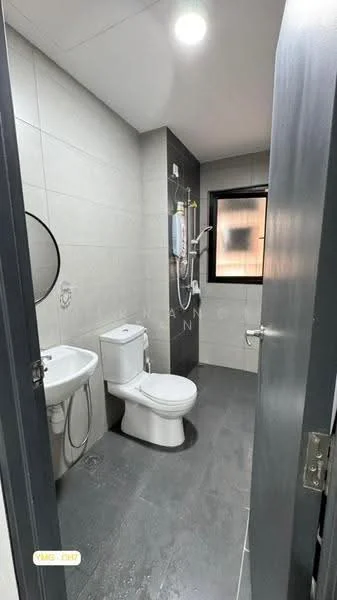 Bathroom features: grey tiled walls, light grey tiled flooring, one-piece toilet, chrome basin mixer, round mirror, shower with handheld showerhead, wall-mounted water heater, window for natural light, towel rack; style: modern.