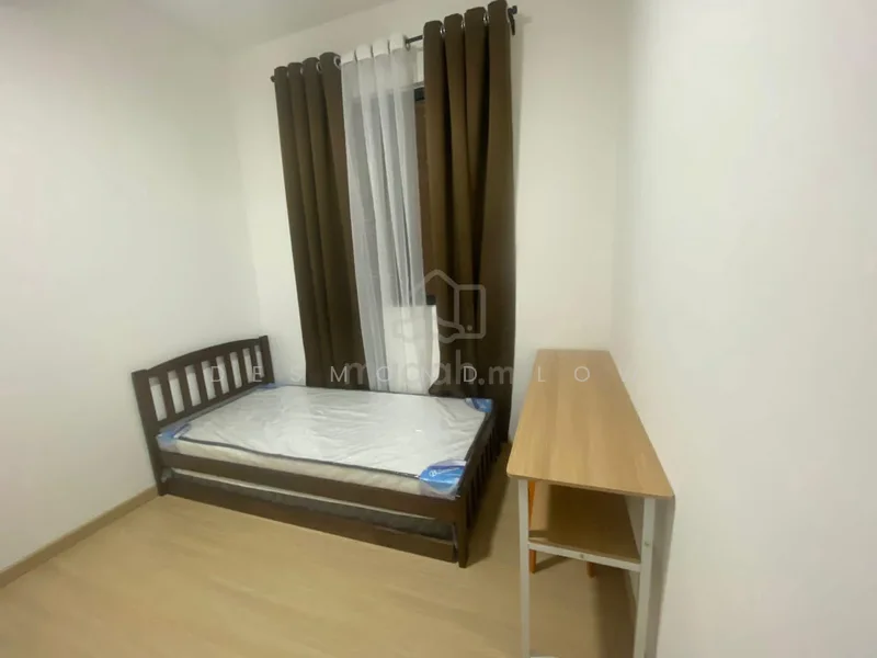 Bedroom features: single bed frame, mattress without bedding, wooden bed frame, brown curtains, sheer white curtains, light wood flooring, white painted walls, study desk, chair; style: minimalist.