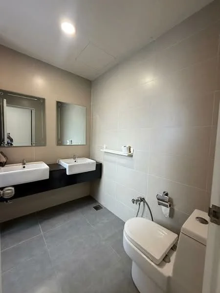 Bathroom features: two single-bowl ceramic sinks, black wall-mounted vanity, large framed mirrors, chrome basin mixers, white one-piece toilet, grey tile flooring, light grey wall tiles, wall-mounted shelf, recessed ceiling lights; style: modern.