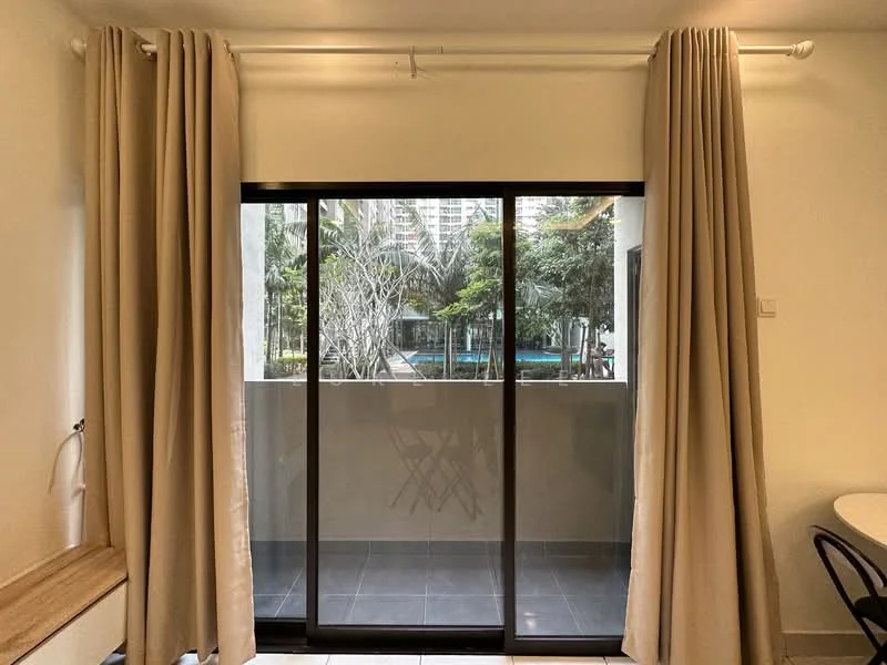 Room features: floor-to-ceiling sliding glass door, beige curtains, grey tiled flooring, white painted walls, view of outdoor greenery and swimming pool; style: modern; view: pool.