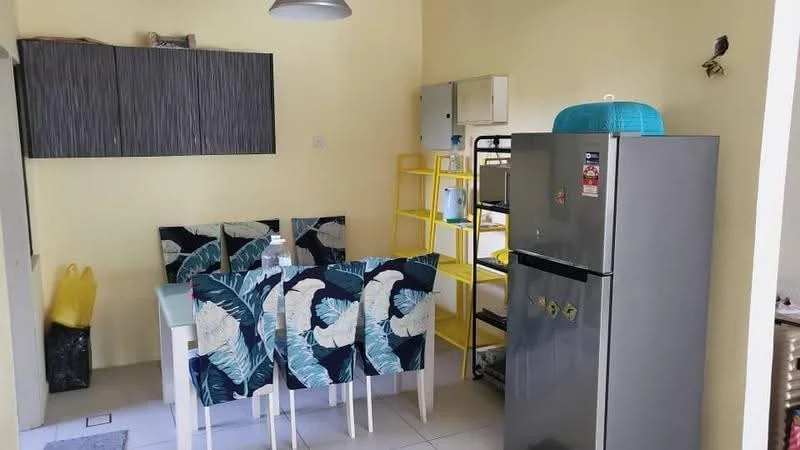 Dining features: white dining table, 4 dining chairs with tropical leaf pattern, yellow open shelving unit, grey refrigerator, grey wall cabinet, light fixture, cream painted walls, tile flooring; style: modern.