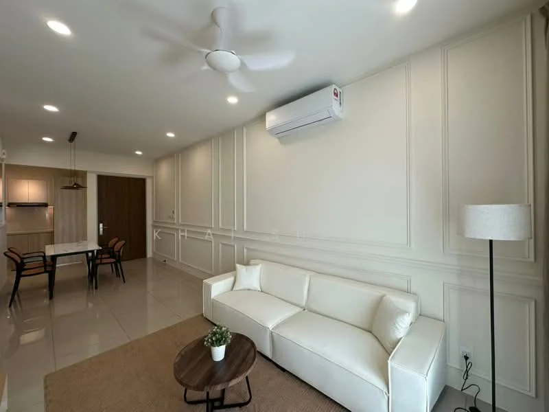 Living features: white leather sofa, round wooden coffee table, 5-blade ceiling fan, wall-mounted split AC, recessed LED downlights, cream painted walls with panel moulding, glossy tile flooring, area rug, decorative plant in ceramic pot; style: modern. Kitchen features: kitchen island with seating, stainless-steel fridge, built-in oven, ceramic tile backsplash, white cabinetry; style: modern.