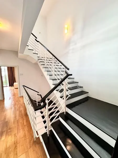 Room features: wooden flooring, white painted walls, black and white staircase, metal railing, recessed lighting, natural light from windows, open space, high ceiling; style: modern.