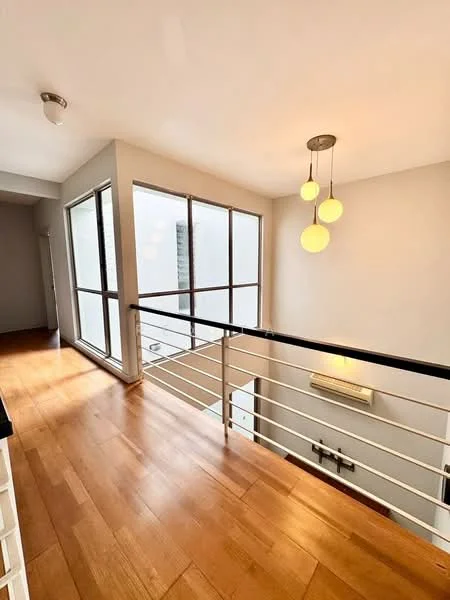 Hallway features: wooden flooring, white painted walls, ceiling light fixture with three pendant bulbs, floor-to-ceiling windows, metal railing, wall-mounted air conditioning unit; style: modern.