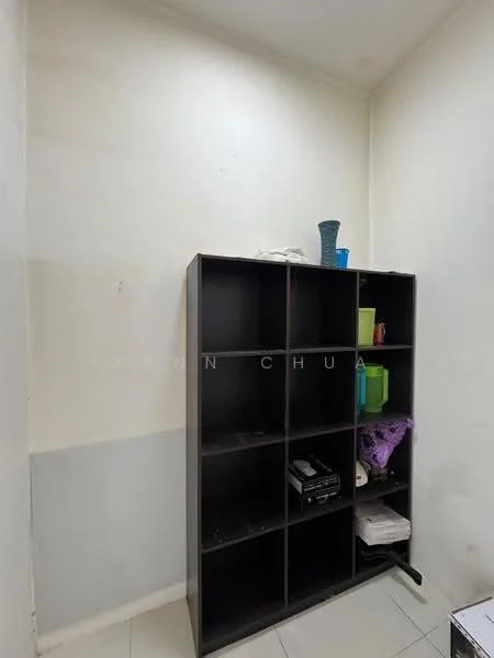 Room features: white painted walls, grey accent wall, tile flooring, black shelving unit, various colored storage containers, decorative vase, printer, purple cloth.