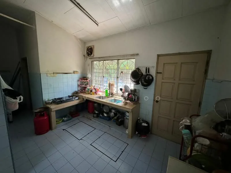 Kitchen features: single-bowl stainless-steel sink, chrome pull-down faucet, wooden countertop, blue tiled backsplash, white tiled walls, light blue tiled flooring, wall-mounted window with metal grilles, kitchen cabinets, various cooking utensils, multiple pots and pans, stove with cooking surface, refrigerator, open shelving, seating area with chair.