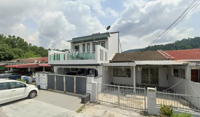 Exterior type: semi-detached house; features: white painted facade, flat roof, two-storey structure, balcony with glass railing, manicured lawn, paved driveway, fenced front yard, satellite dish on roof, surrounded by greenery, car porch with awning; style: modern.