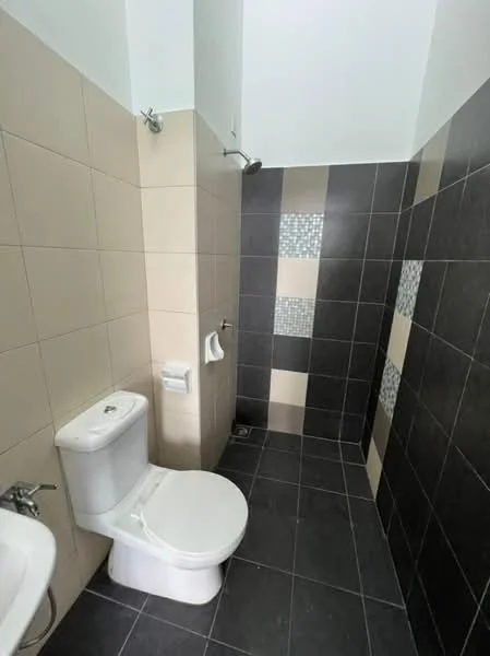 Bathroom features: one-piece toilet, shower area with wall-mounted shower head, grey ceramic tile flooring, beige wall tiles, decorative mosaic tile accents, toilet paper holder, towel holder, chrome faucet, sink with pedestal, corner shower; style: modern.