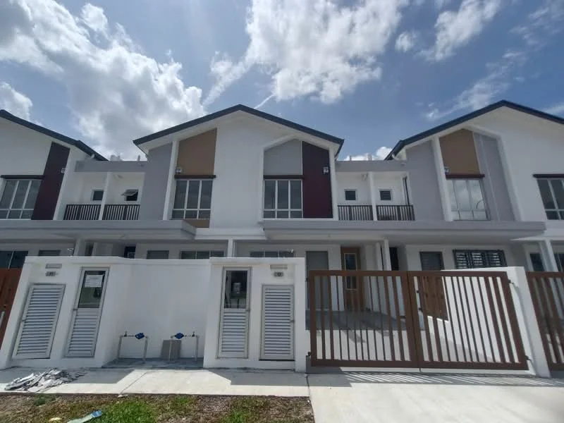 Exterior type: linked terrace house; features: white painted facade, red accent panels, flat roof, two-storey structure, manicured lawn, paved driveway, security gate, front porch, balconies on upper floor, large windows, visible plumbing fixtures, surrounded by clear blue sky; style: modern.