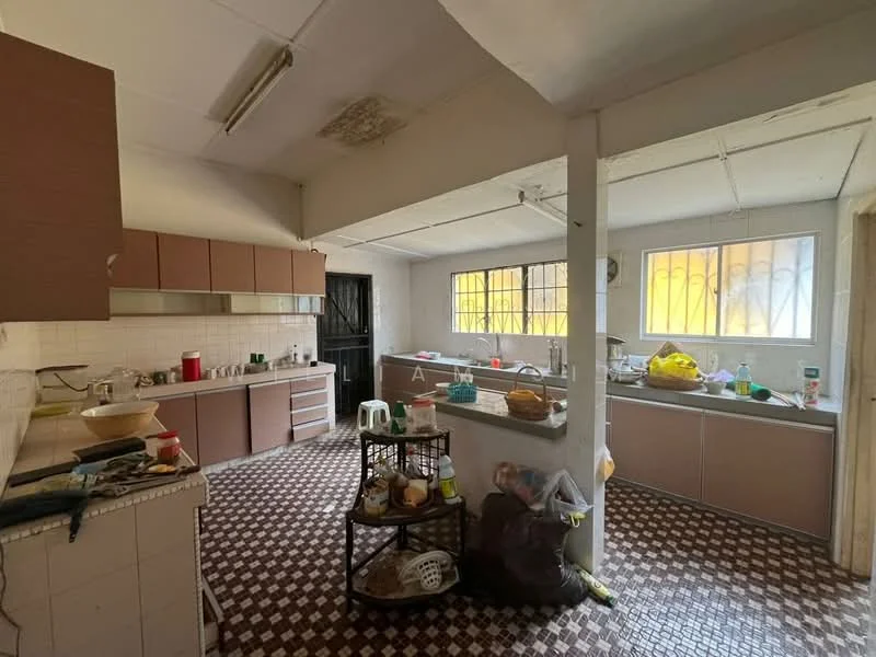 Kitchen features: brown cabinetry, white tiled backsplash, double-bowl stainless-steel sink, chrome pull-down faucet, countertop with grey surface, built-in oven, freestanding range oven, refrigerator, window with metal grilles, tile flooring with geometric pattern, kitchen island, open shelving, various kitchen appliances and utensils, natural light from windows.