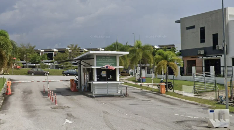 Exterior type: main entrance gate; features: guard house at entrance, boom gate, paved driveway, landscaped greenery, palm trees, parking area, security barriers, visible residential units in background; style: modern.