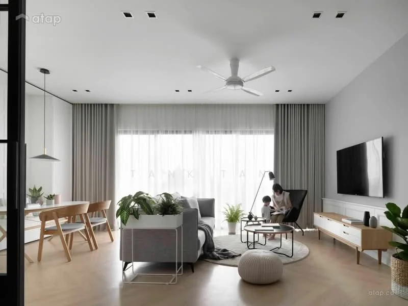 Living features: light wood flooring, white painted walls, tray ceiling with recessed lighting, 5-blade ceiling fan with light, floor-to-ceiling windows with sheer curtains, grey fabric sofa, black metal coffee table, area rug with neutral tones, TV console with wall-mounted TV, decorative plants in ceramic pots, dining table with wooden chairs; style: modern.