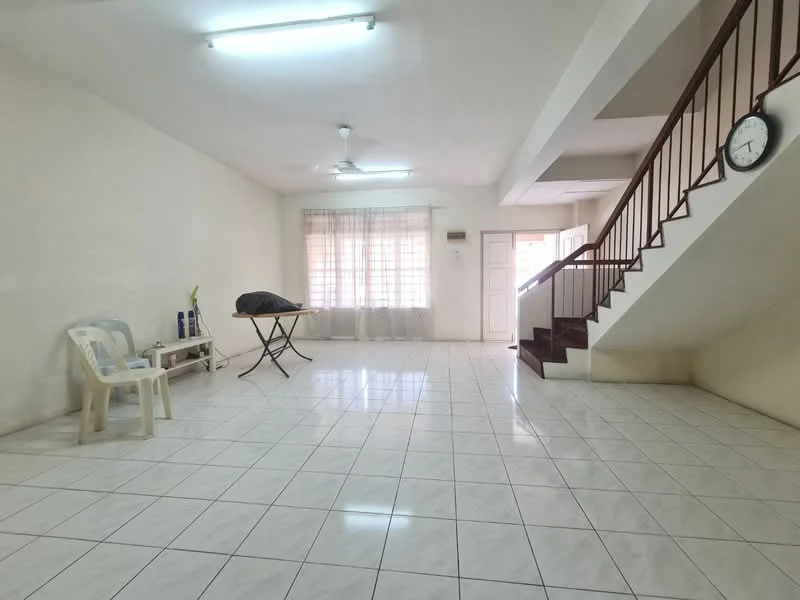 Living features: white painted walls, glossy white tile flooring, 5-blade ceiling fan, large window with sheer curtains, wooden staircase, clock on wall, folding table, plastic chair.