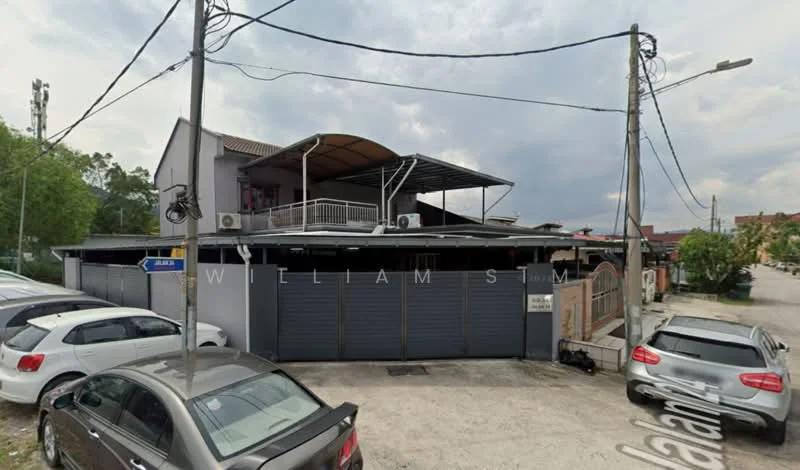 Exterior type: detached bungalow; features: two-storey building, grey painted facade, flat roof with overhang, multiple air conditioning units, metal gate, parking area with multiple vehicles, surrounding street view, balcony on the upper floor, concrete driveway, fenced perimeter; style: modern.