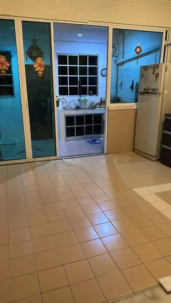 Kitchen features: ceramic tile flooring, white walls, window with grid pattern, stainless-steel fridge, sink, countertop, kitchen cabinets, kitchen utensils visible, open layout to living area.