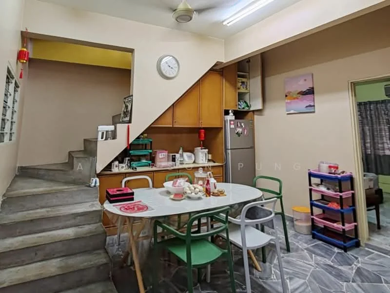 Kitchen features: wood cabinetry, white walls, grey tile flooring, round dining table, green dining chairs, stainless-steel sink, built-in oven, microwave, kettle, toaster, refrigerator, ceiling fan, wall clock, staircase leading to upper level; style: modern.