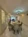 Dining features: round dining table, upholstered dining chairs, chandelier, recessed downlights, marble flooring, cream painted walls, decorative wall paneling, wall-mounted air conditioning unit; style: modern.