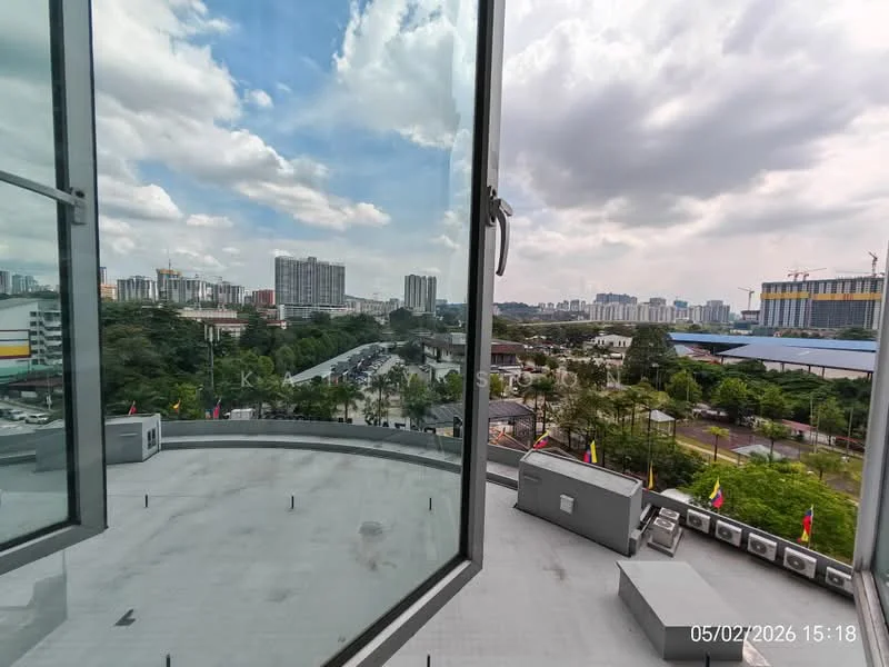 Exterior type: high-rise condominium; features: floor-to-ceiling windows, balcony with city view, concrete facade, surrounded by greenery, urban skyline in background, visible neighboring buildings, open-air balcony, roof deck; style: modern.