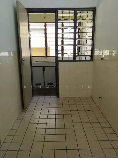 Room features: white tiled walls, cream tiled flooring, square grid window with metal grille, wooden cabinet, door leading to another room, natural light from window.